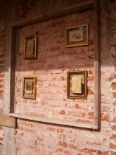 A brick wall with pictures on