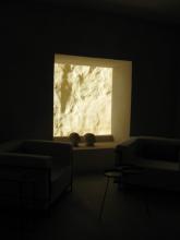 A dark room with a bright window