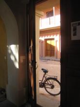 An open door with a bycicle outside