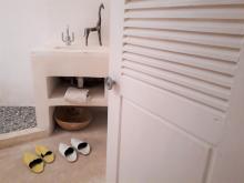 Aminou room with shoes on the floor.