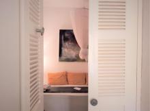 A view of the Aminou bed through a doorway.