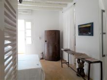 A view of the Aminou room with bed and wardrobe in view.