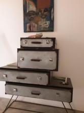 A chest of drawers made of suitcases