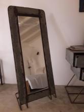 A mirror showing a reflection of the room