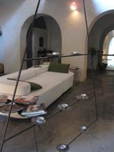 A white sofa, and a large ornamental candle holder