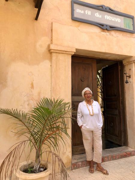 Marie-Caroline Camara in front of Au Fil du Fleuve.